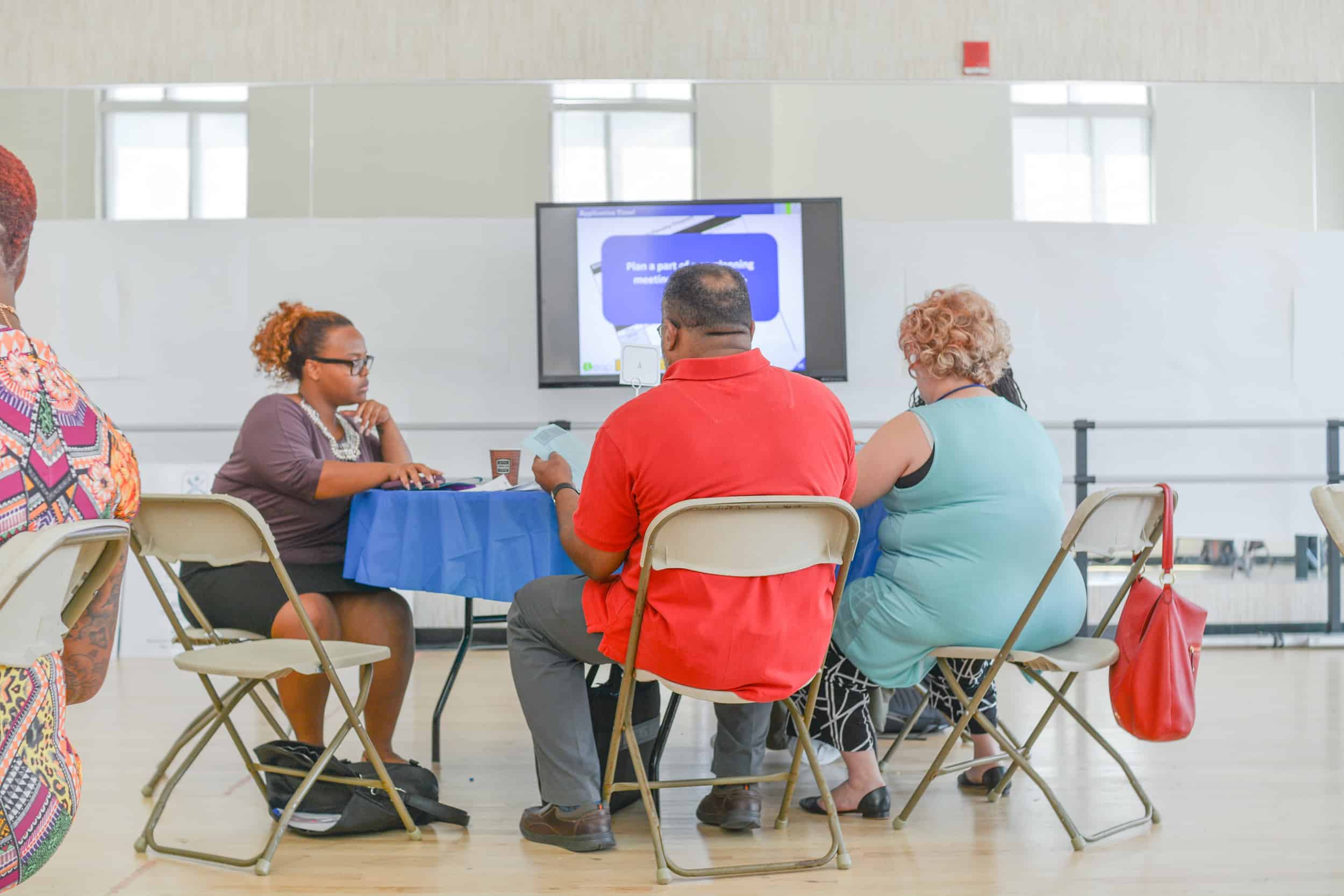 Four educators sit at a round table looking at a worksheet