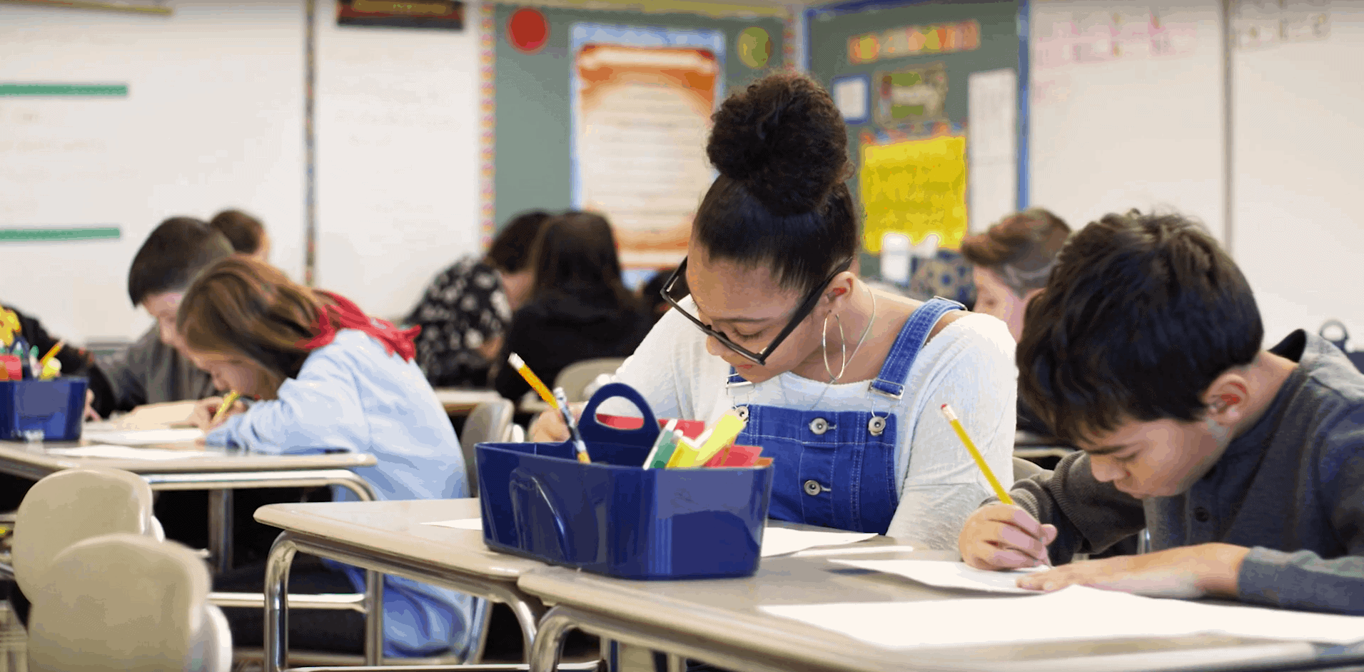 A classroom of students work in pairs on an assignment