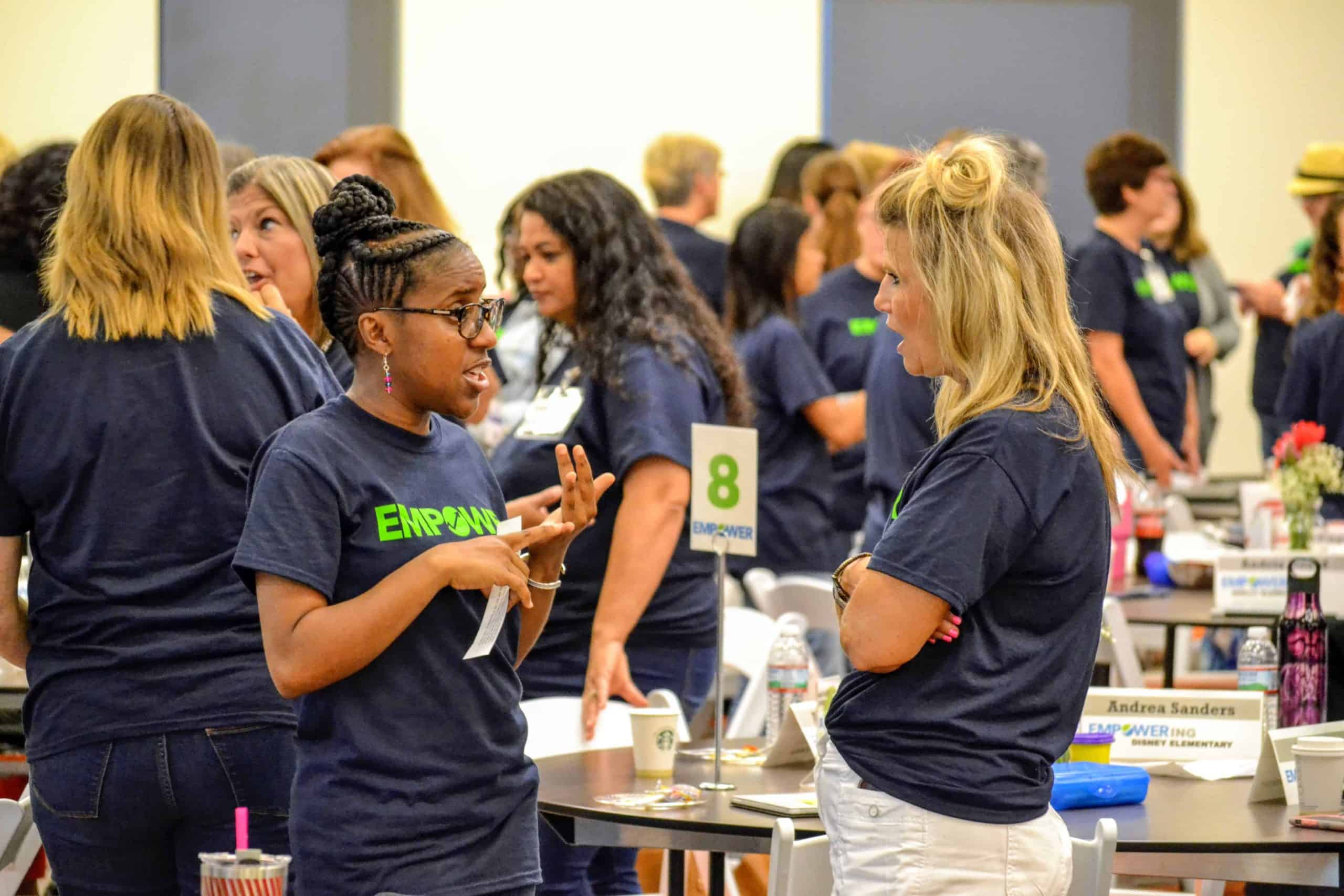 Two Tulsa Empower educators chat during a workshop