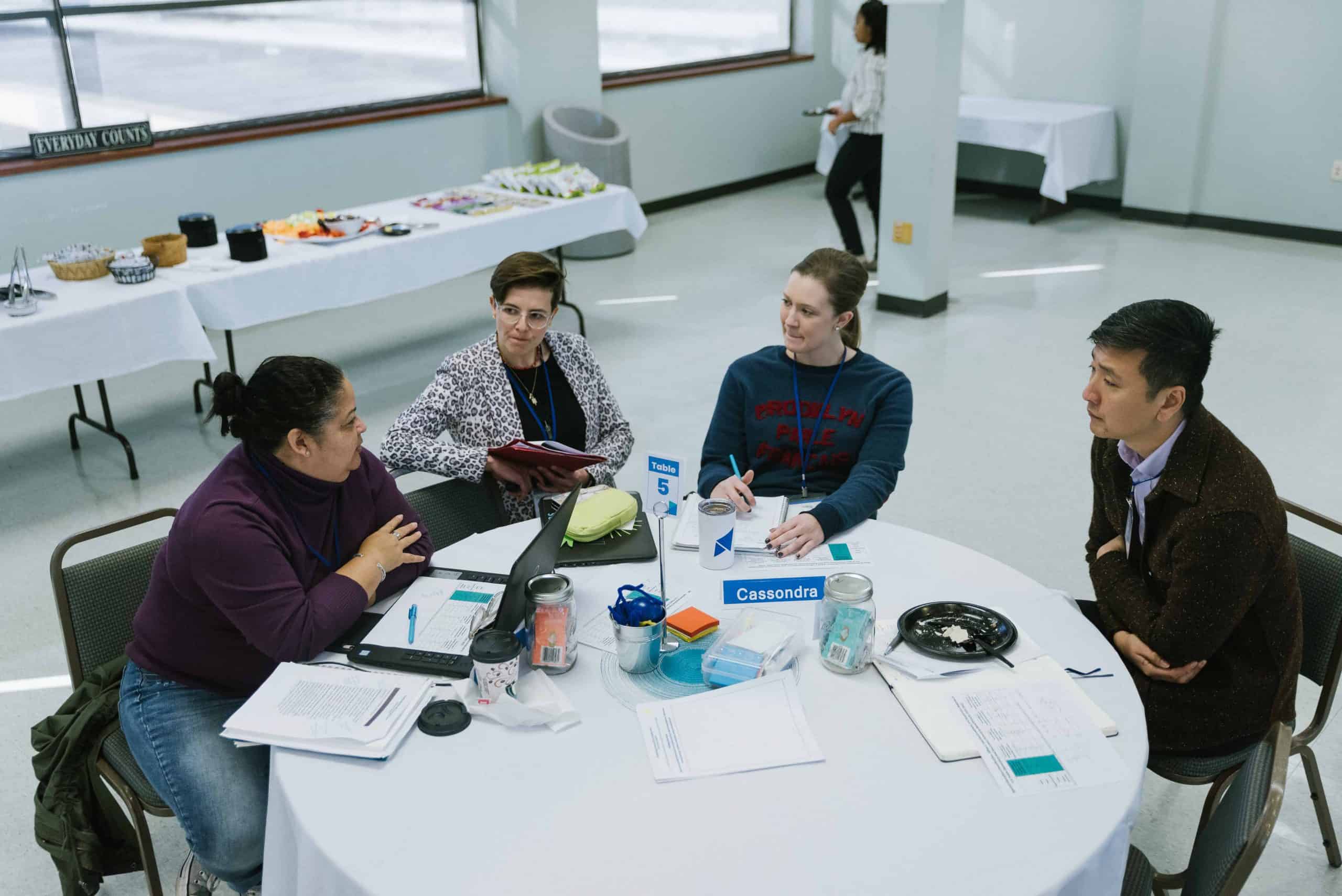 Chong-Hao Fu, Rachel Scarpato and Louisiana teachers talk around a table