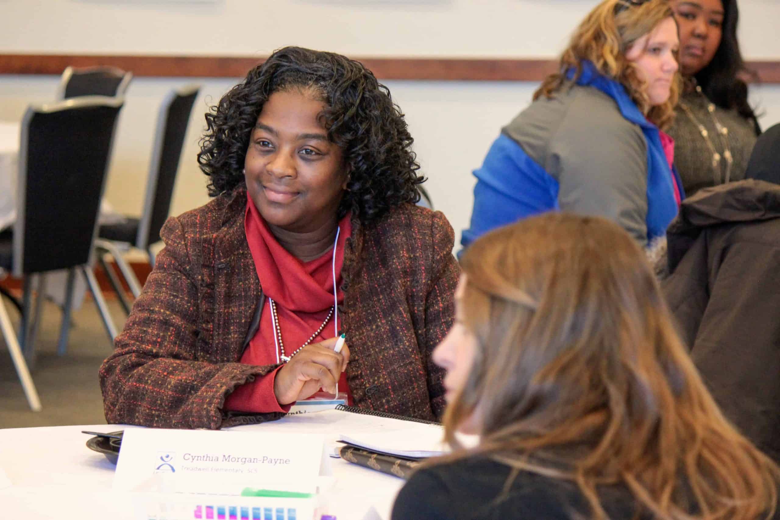 A participant in the Memphis fellowship sits at a table and smiles.