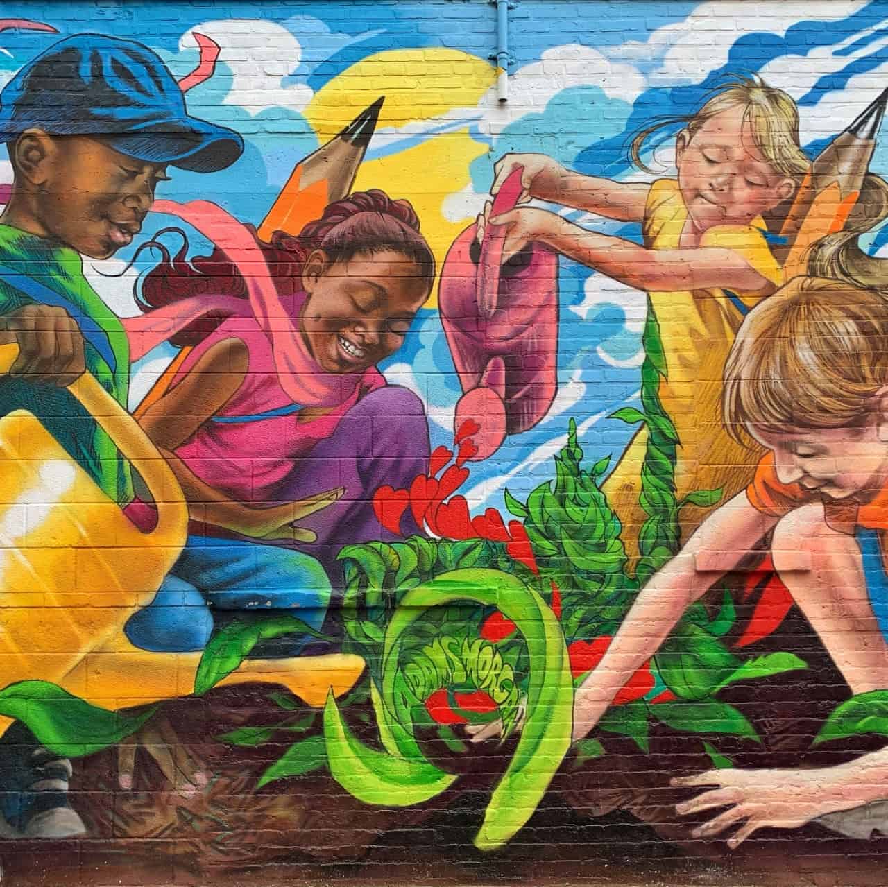 mural of kids planting a garden together