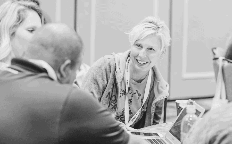 Three Grand Rapids educators discuss at a table