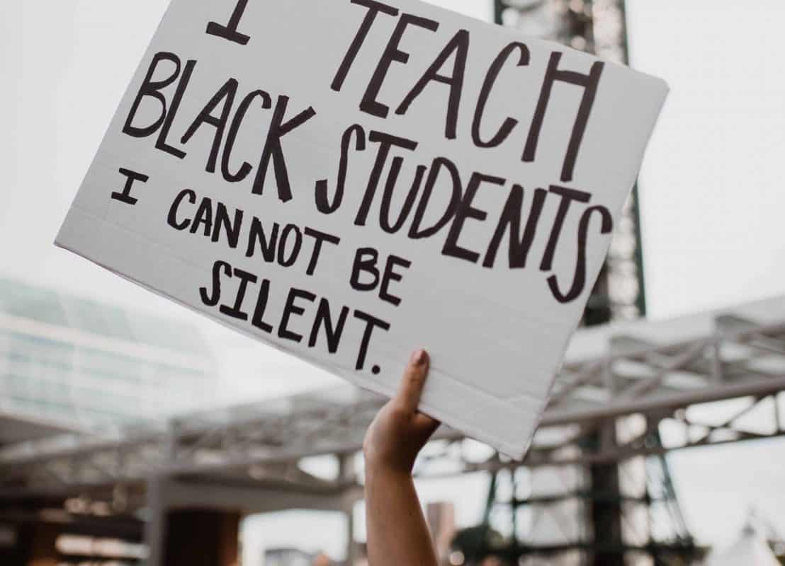 Sign reads "I Teach Black Students I Cannot Be Silent"