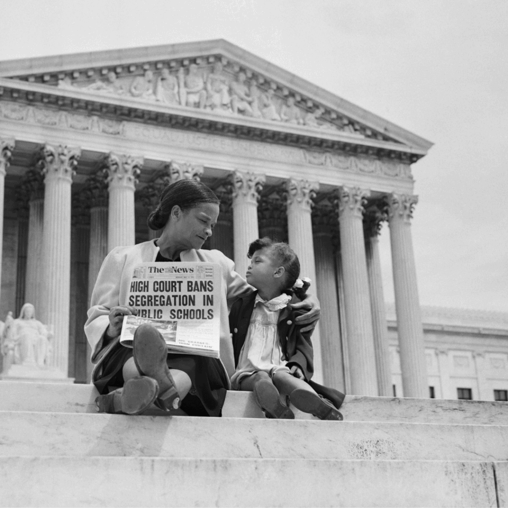 a mother and daughter sit on the steps of the U.S. supreme court