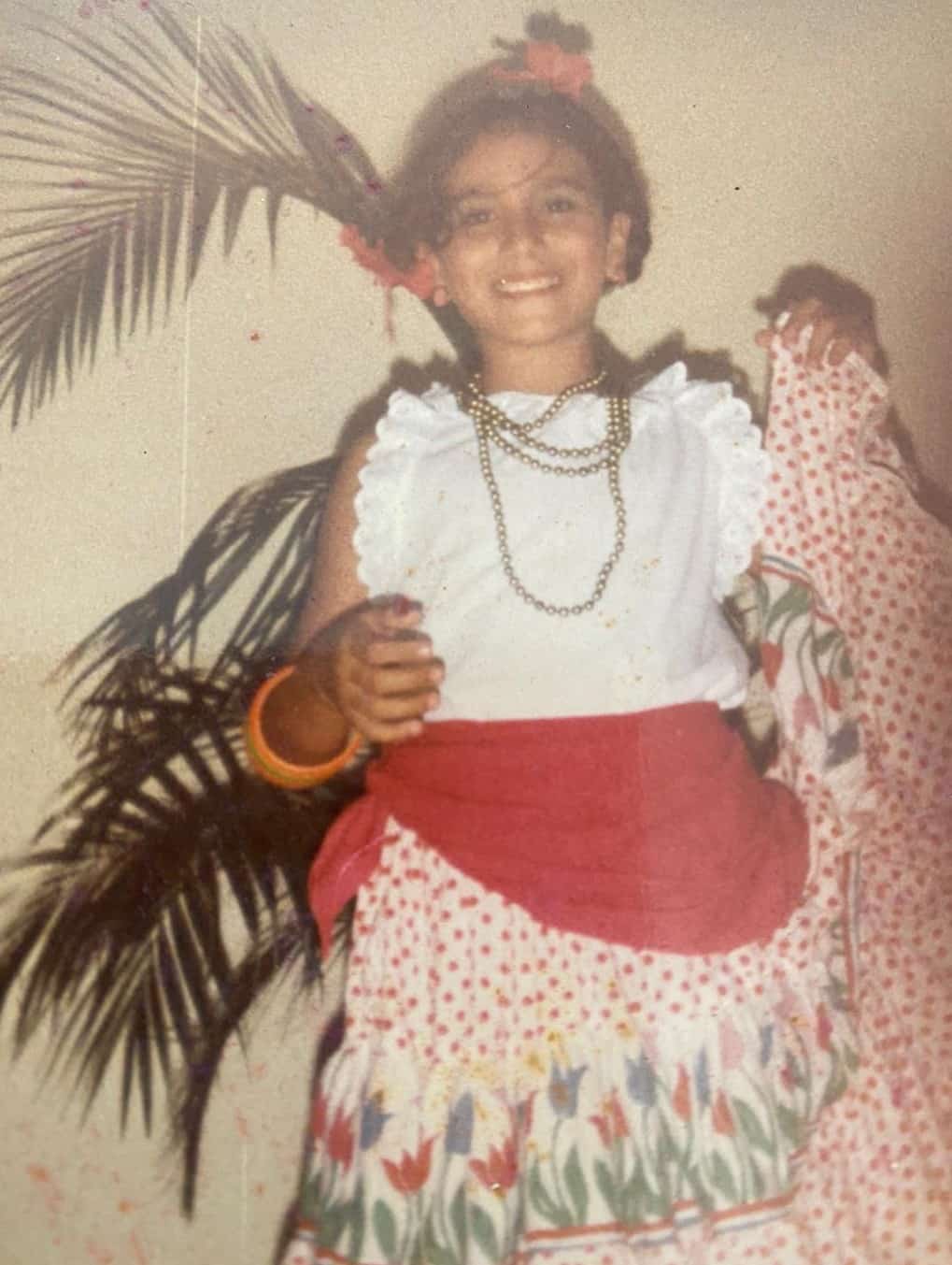 Ariana in a traditional dance costume as a child.