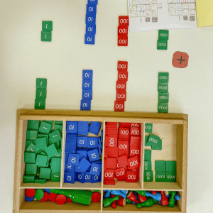 box of math manipulatives in green, red, and blue tiles