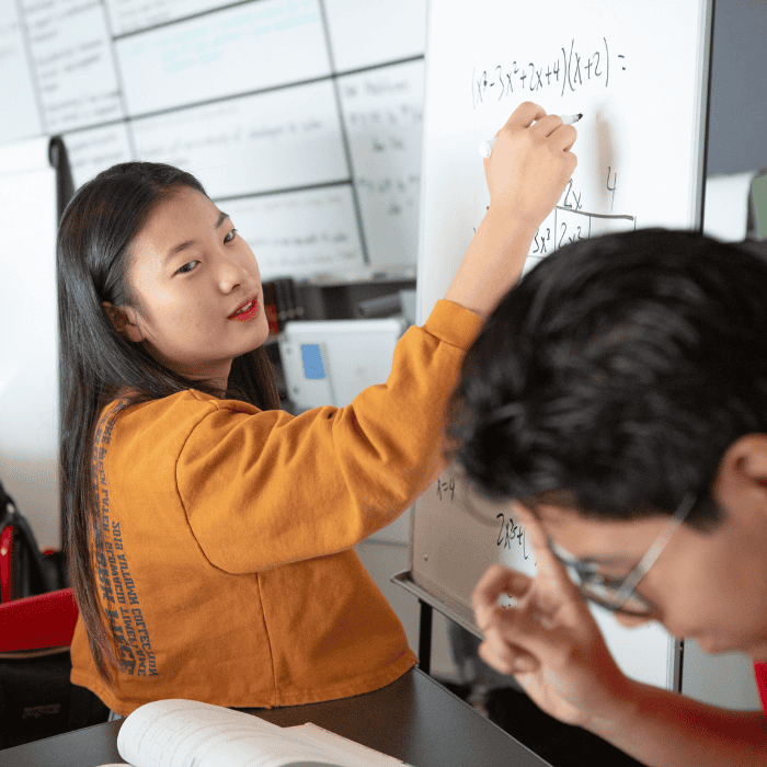 High school girl and boy collaborate on math. Photo by Allison Shelley for EDUimages